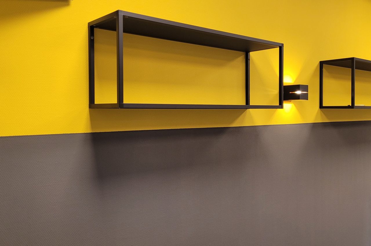 Antraciet grijze kleur in combinatie met geel op de muur